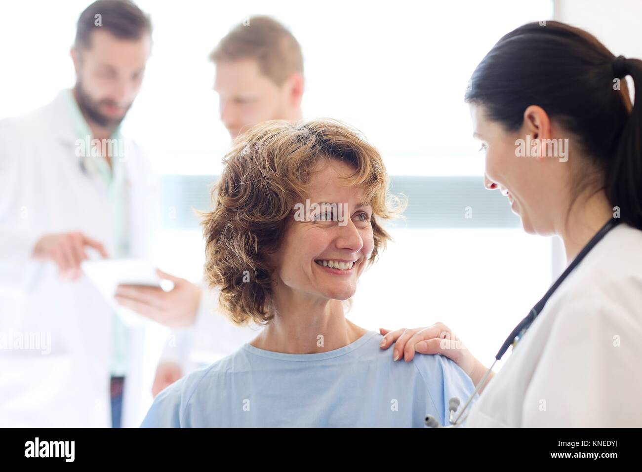Patient in hospital room attended by a doctor, Hospital Stock Photo