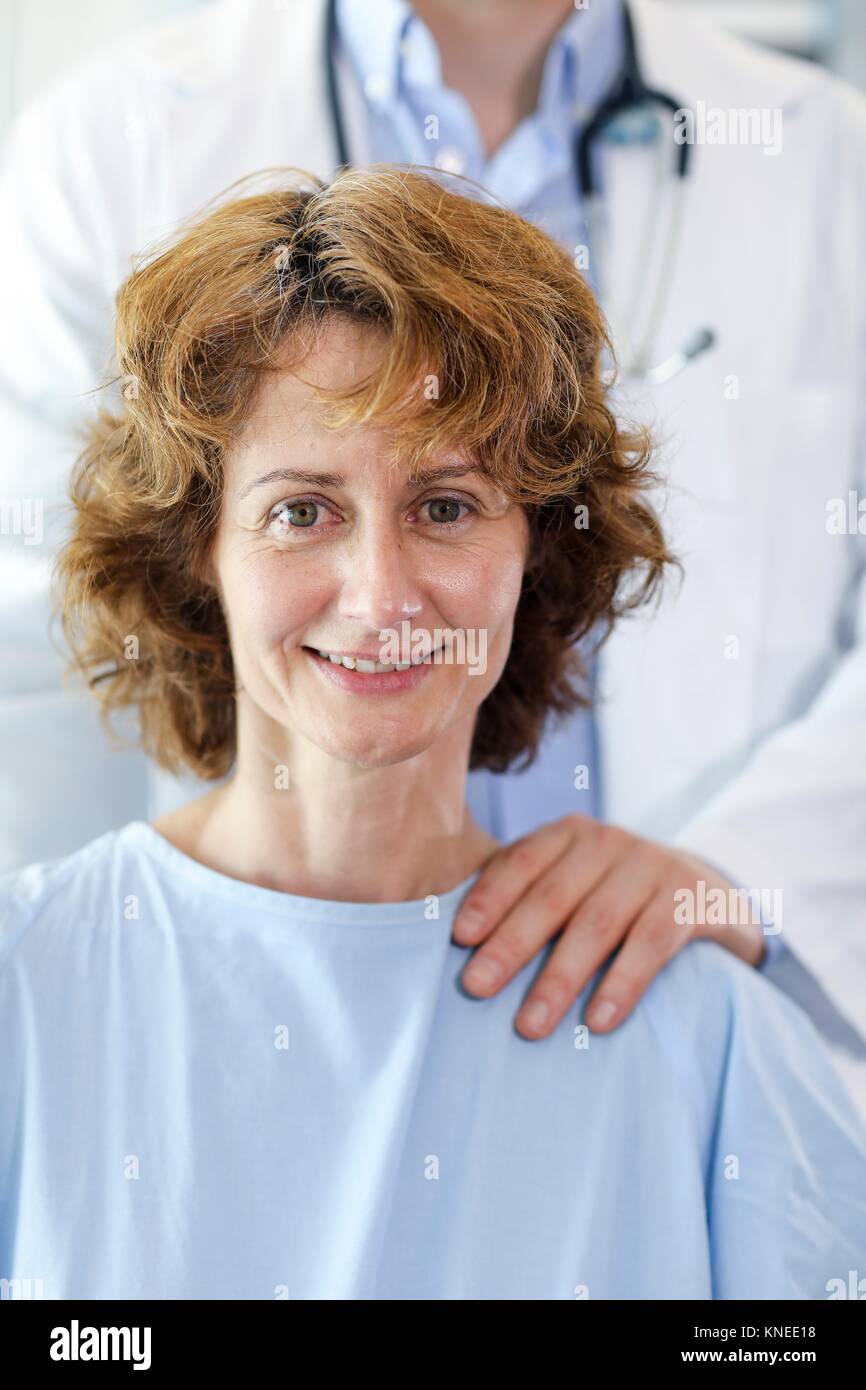 Patient in hospital room attended by a doctor, Hospital Stock Photo