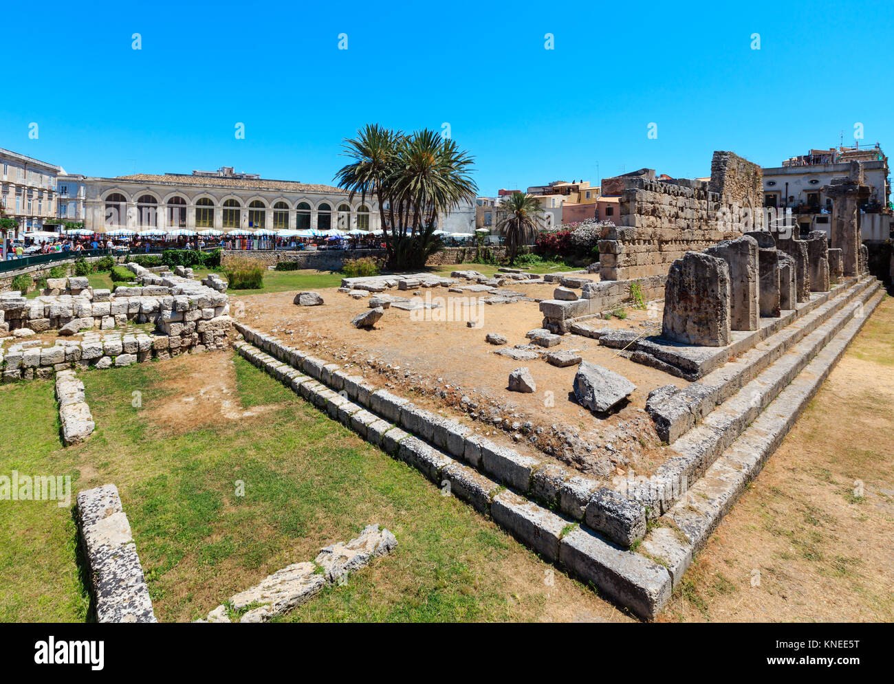 Ruins of Temple of Apollo (ancient Greek monuments on Ortygia island at city of Syracuse, Sicily, Italy). Beautiful travel photo of Sicily. People unr Stock Photo