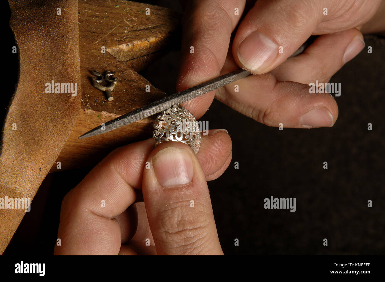 The master jeweler in the workshop processes the stock for the female jewelry Stock Photo