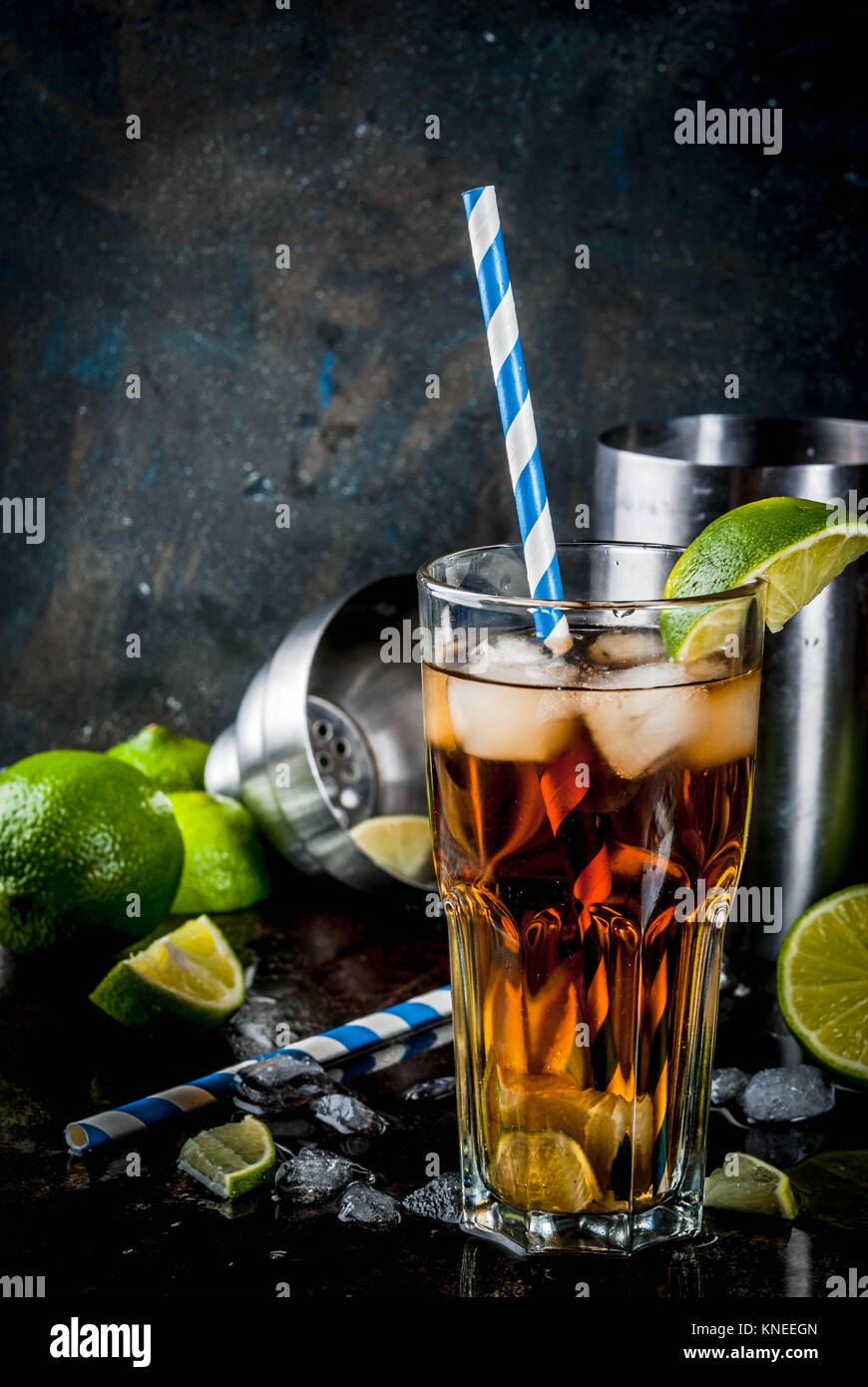 Cuba Libre, long island or iced tea cocktail with strong alcohol, cola, lime and ice, two glass, dark background copy space Stock Photo