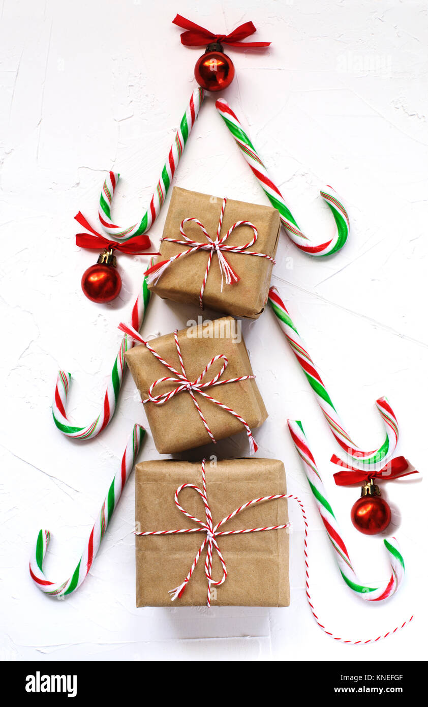 Gift boxes and candy canes in the shape of a Christmas tree Stock Photo ...