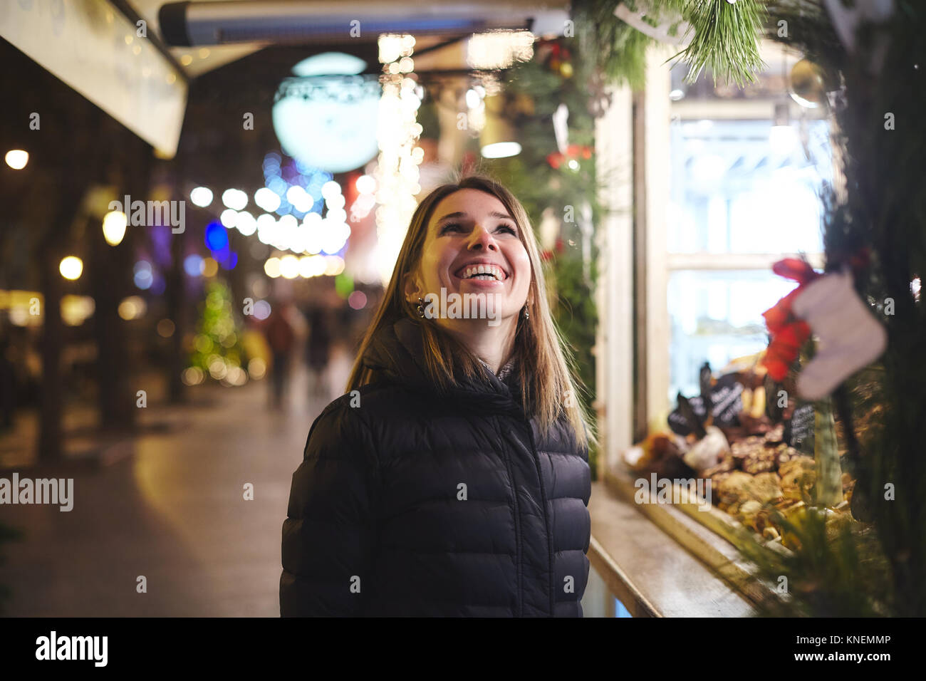Woman at Christmas market looking up smiling, Odessa, Odessa Oblast, Ukraine, Europe Stock Photo