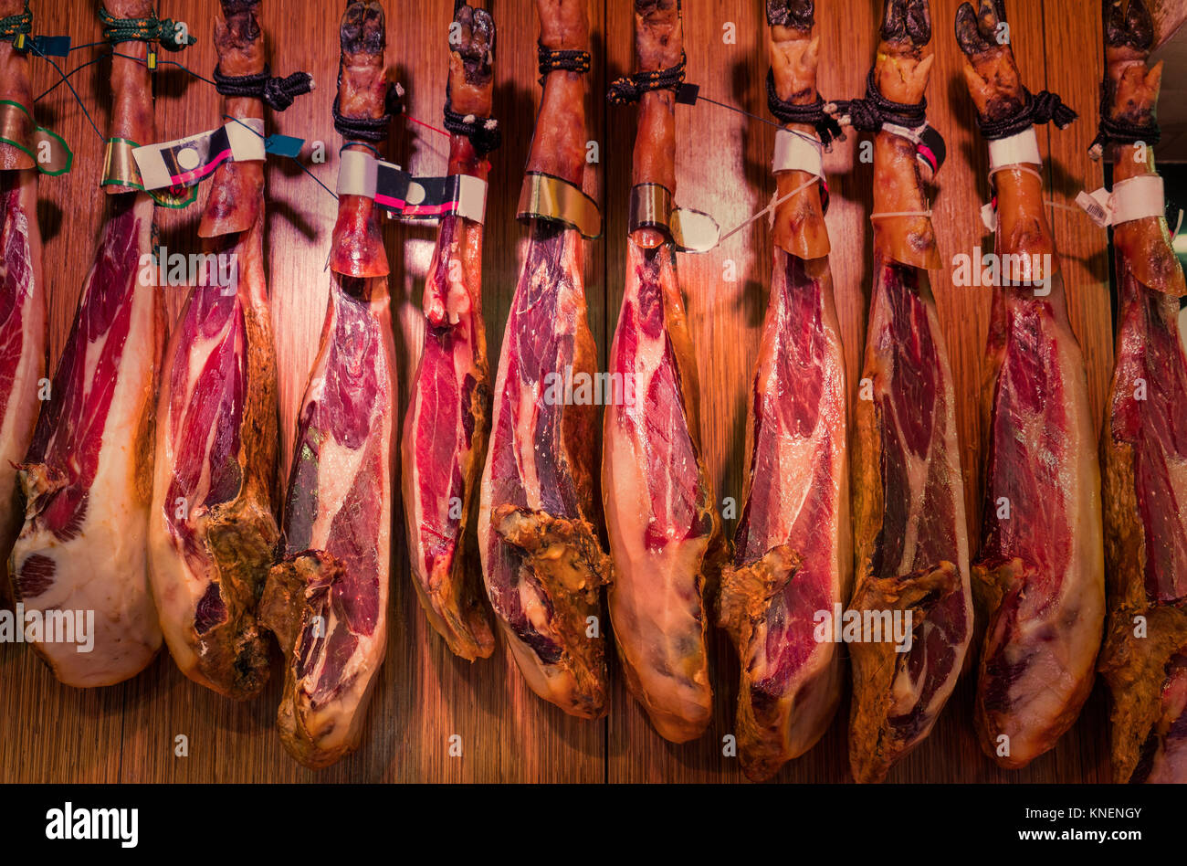 Spanish cured ham hanging in Boqueria Market, Barcelona, Catalonia, Spain, Europe Stock Photo