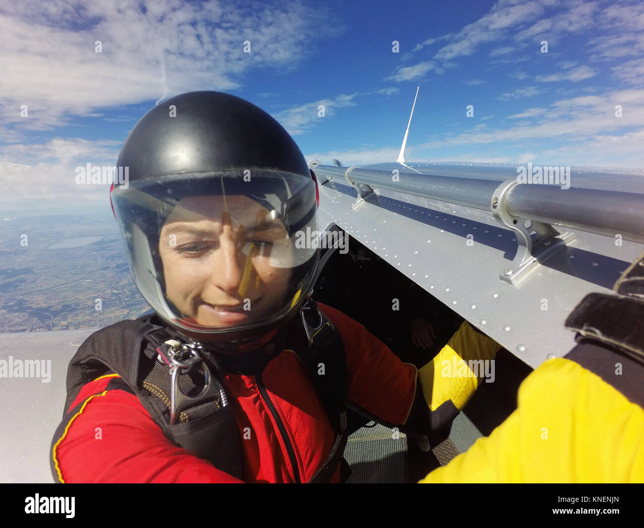 Portrait of female skydiver preparing to jump from aircraft Stock Photo