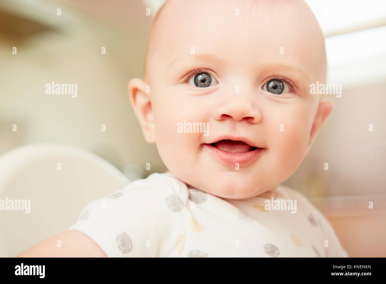 Baby boy sitting in high chair, closeup Stock Photo Alamy