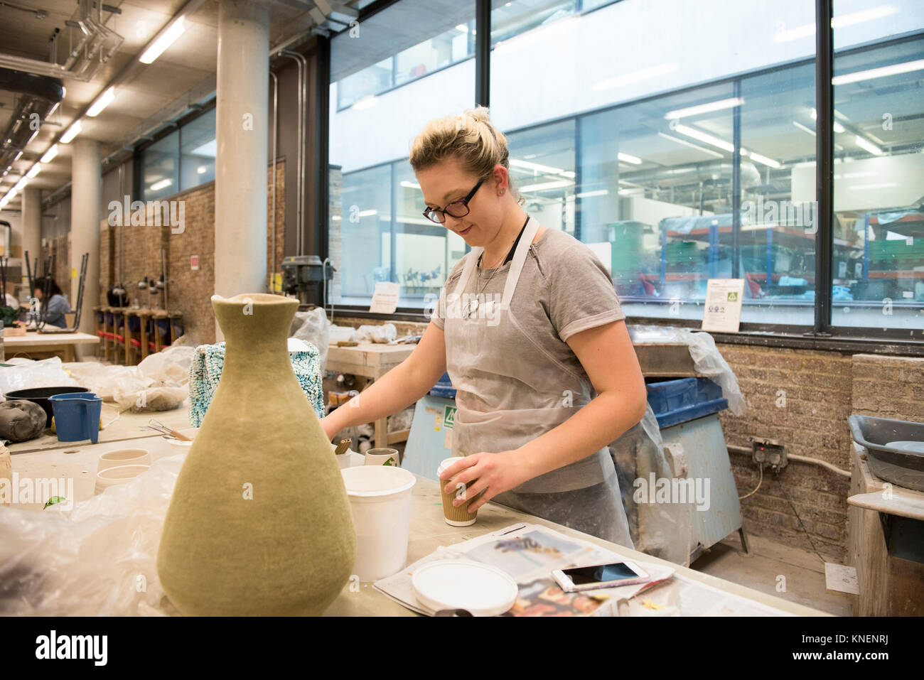 Woman in artist studio making pottery Stock Photo - Alamy