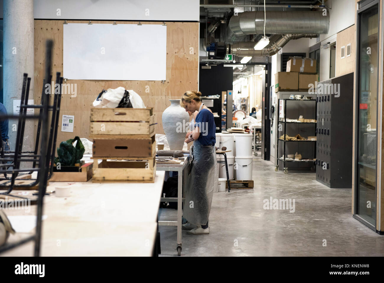 Woman in art studio making pottery Stock Photo - Alamy