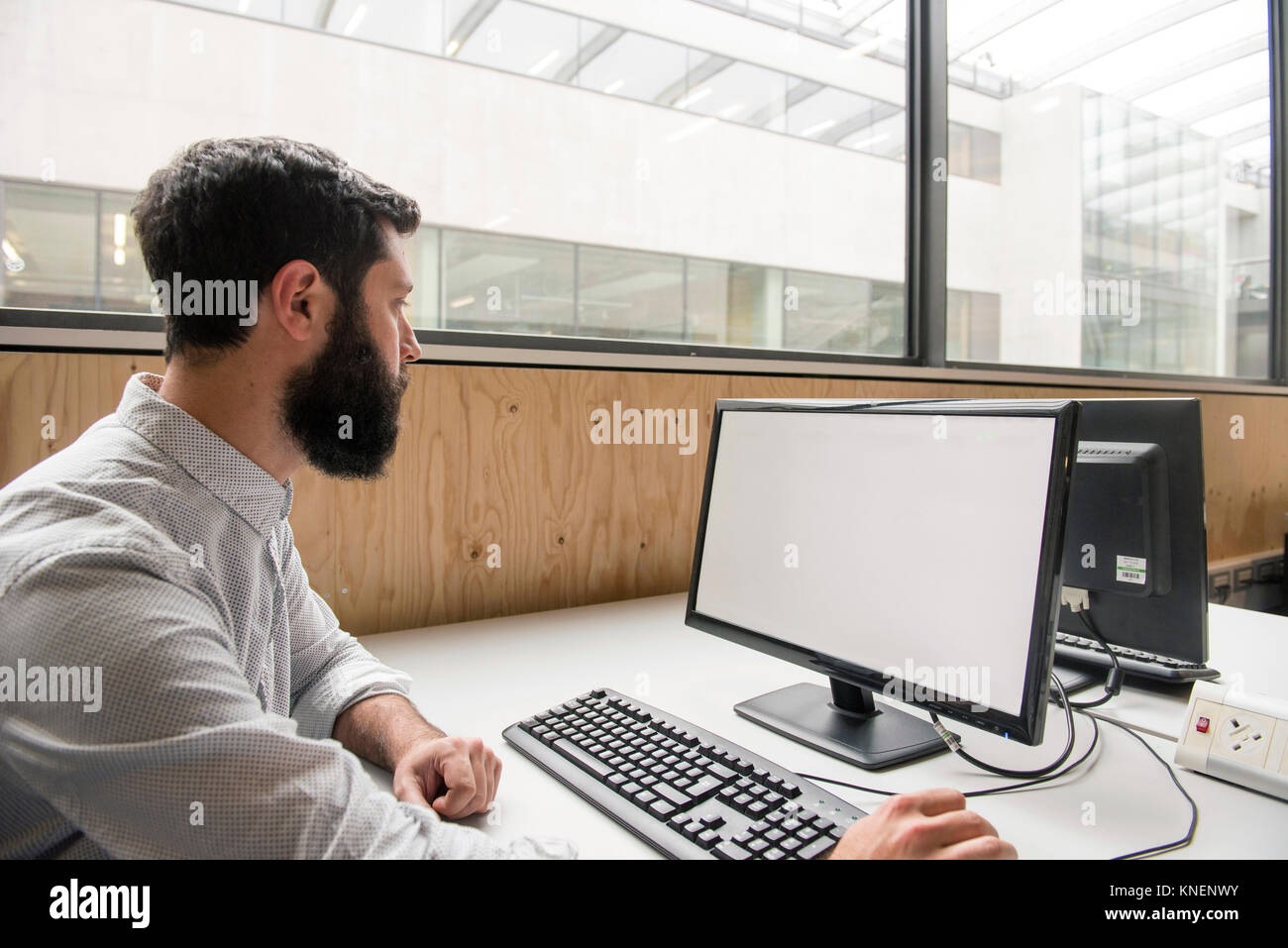 Man in office using desktop computer Stock Photo