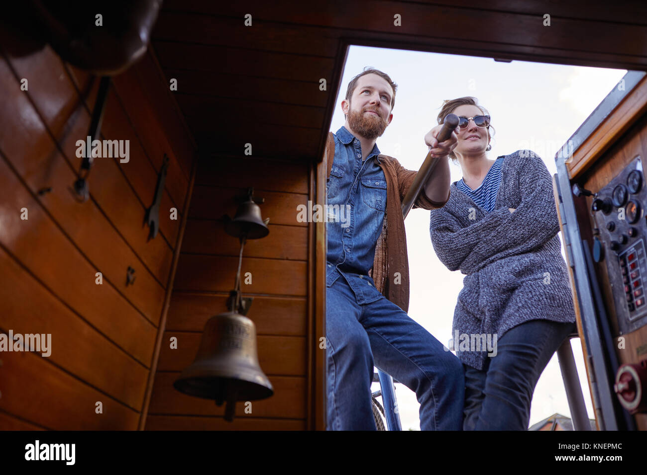 Couple steering canal boat Stock Photo
