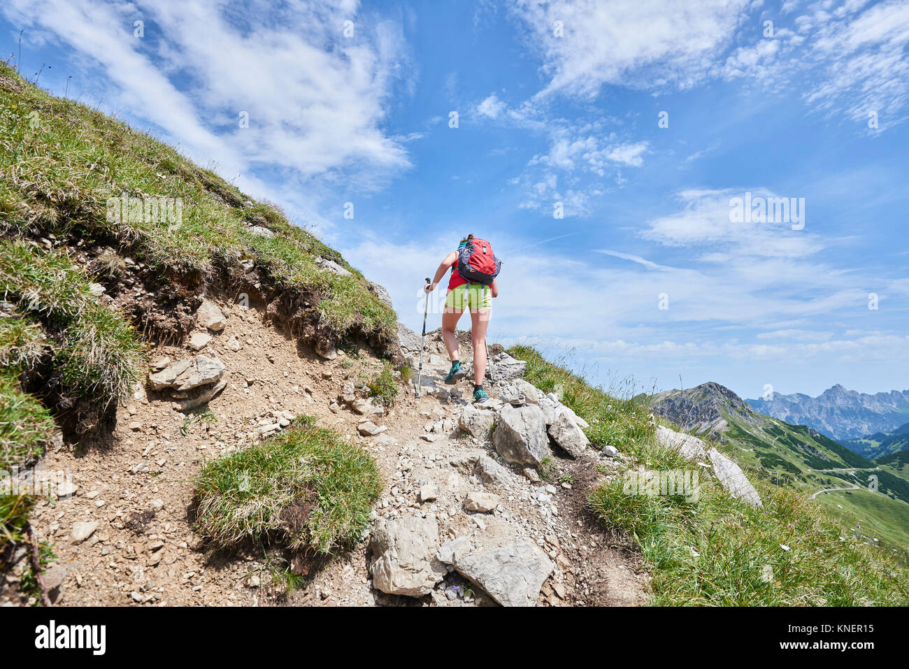 Rear view of female hiker hiking up Tannheim mountains, Tyrol, Austria Stock Photo