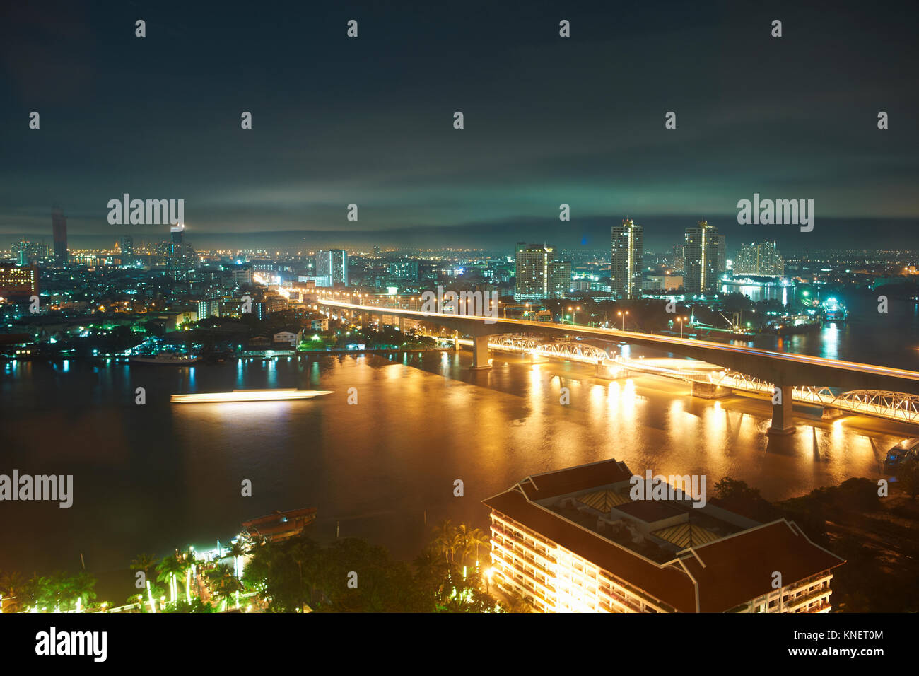 Night cityscape with bridge over Chao Phraya river, Bangkok, Thailand Stock Photo