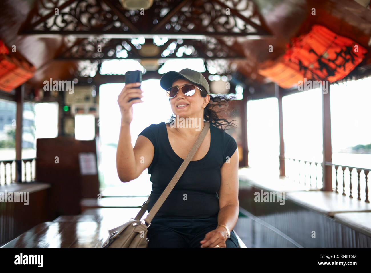 Woman taking selfie with smartphone smiling, Bangkok, Krung Thep, Thailand, Asia Stock Photo