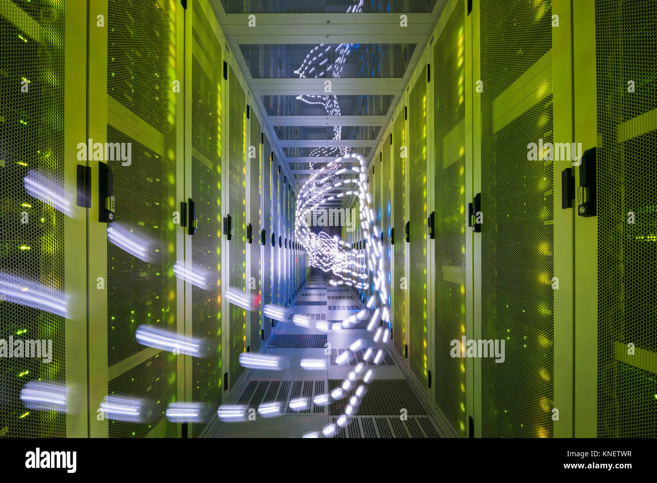 Interior of data centre, lights trails showing travelling data Stock Photo