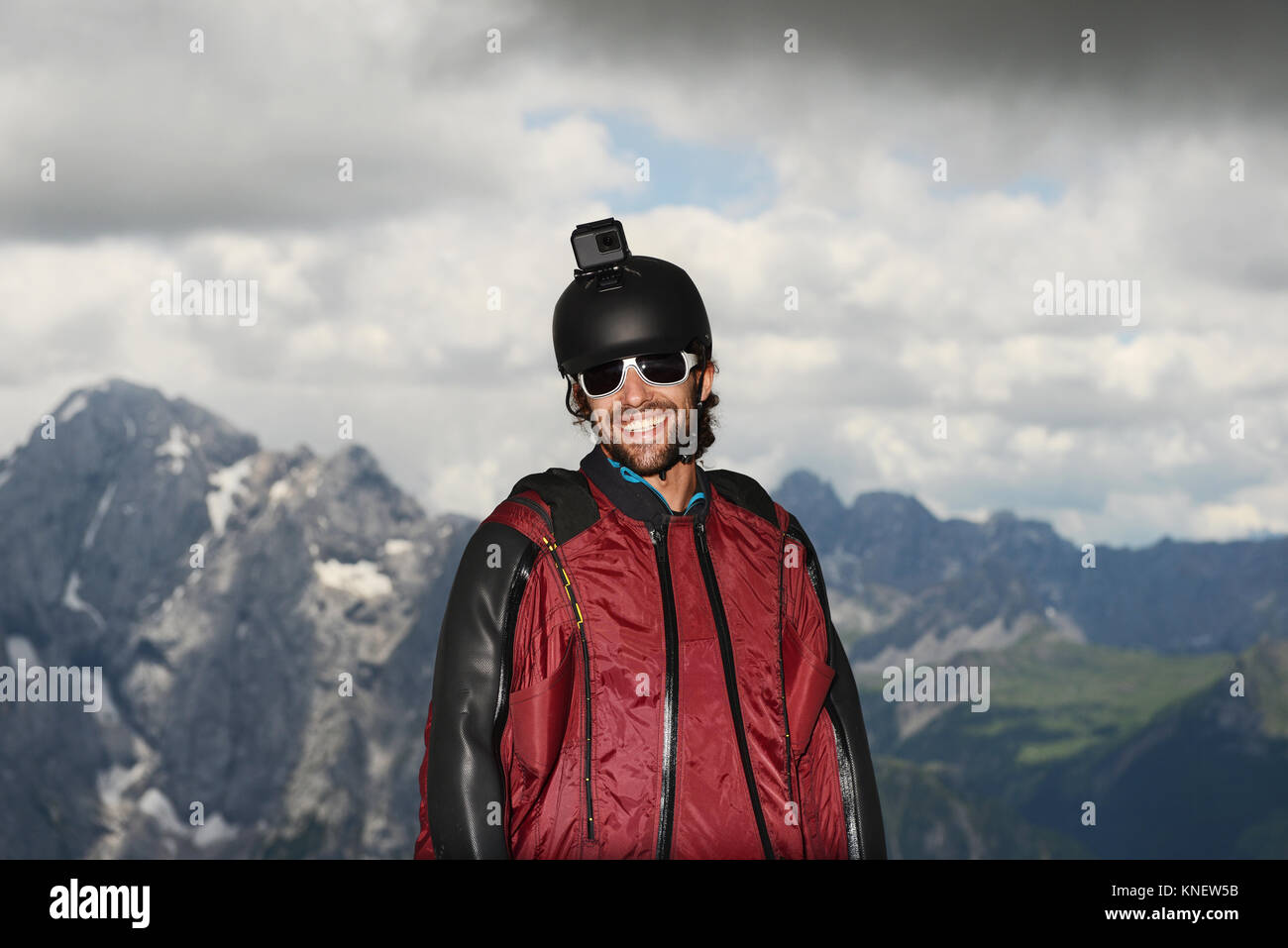 Base jumper wearing wingsuit with action camera on helmet, Dolomite mountains, Canazei, Trentino Alto Adige, Italy, Europe Stock Photo