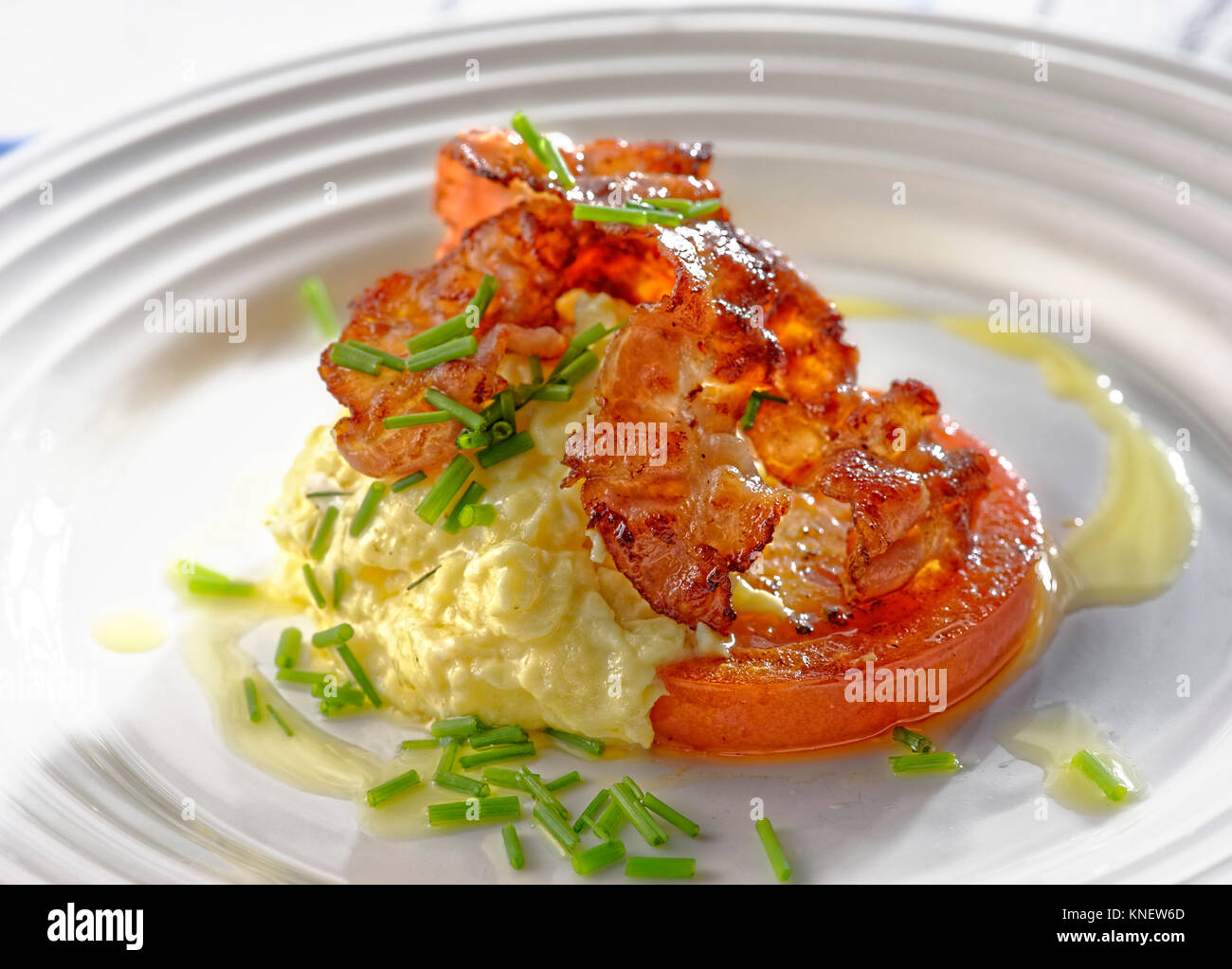 Breakfast plate with scrambled eggs and bacon Stock Photo