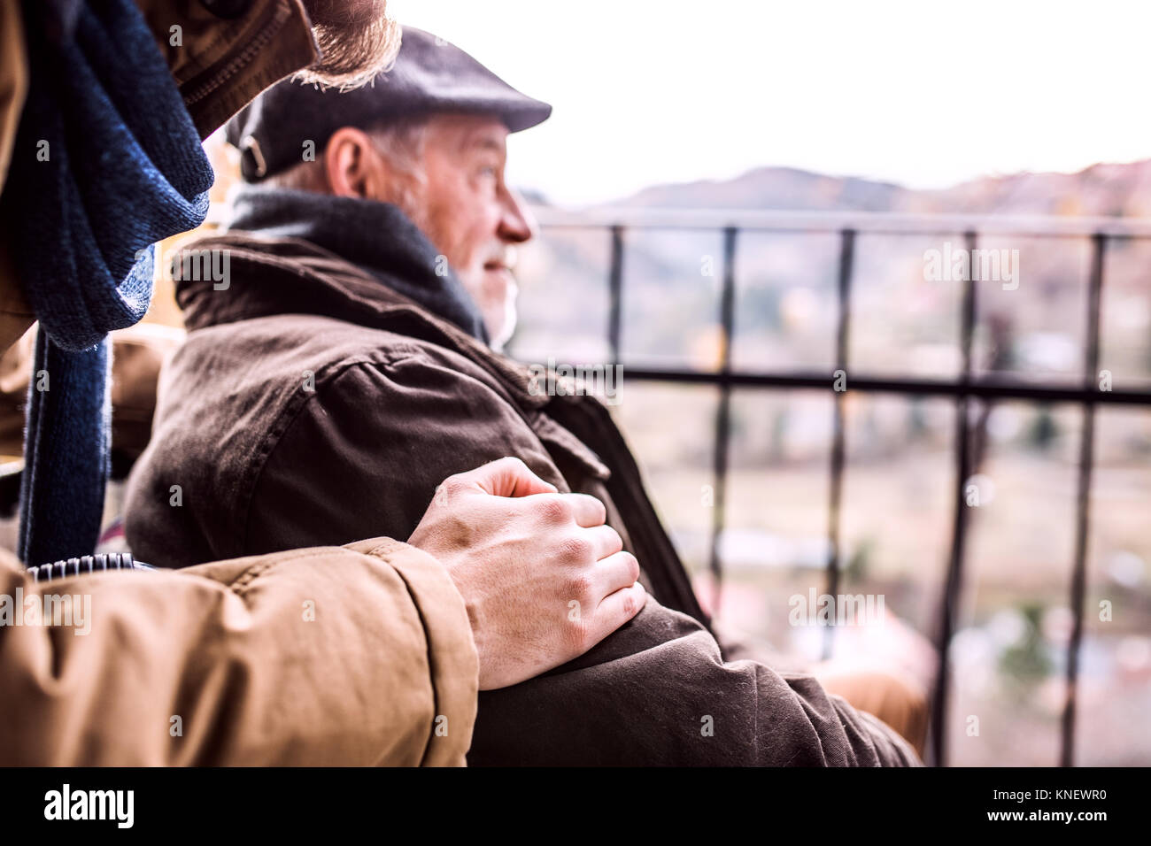 Senior father in wheelchair and young son on a walk. Stock Photo