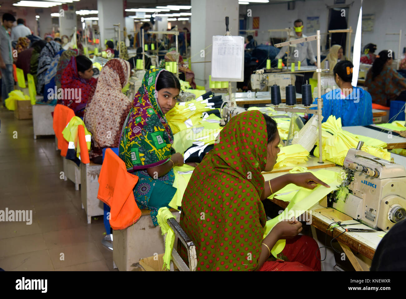 DHAKA, BANGLADESH - DECEMBER 26, 2016: Bangladeshi garments workers work inside a factory at Ashulia, in Dhaka, Bangladesh. Stock Photo