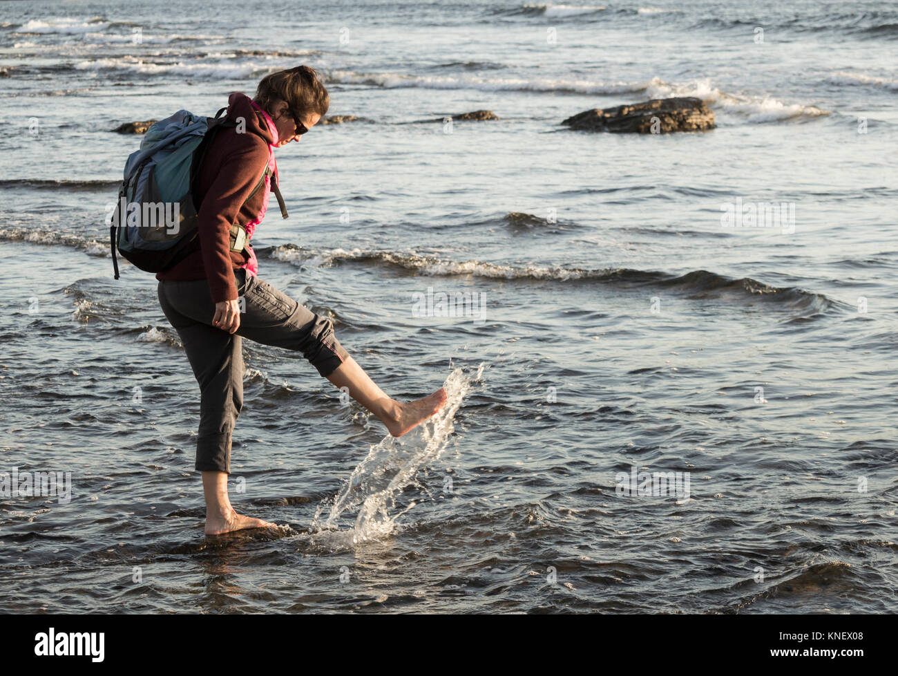 Woman paddling in the sea Stock Photo