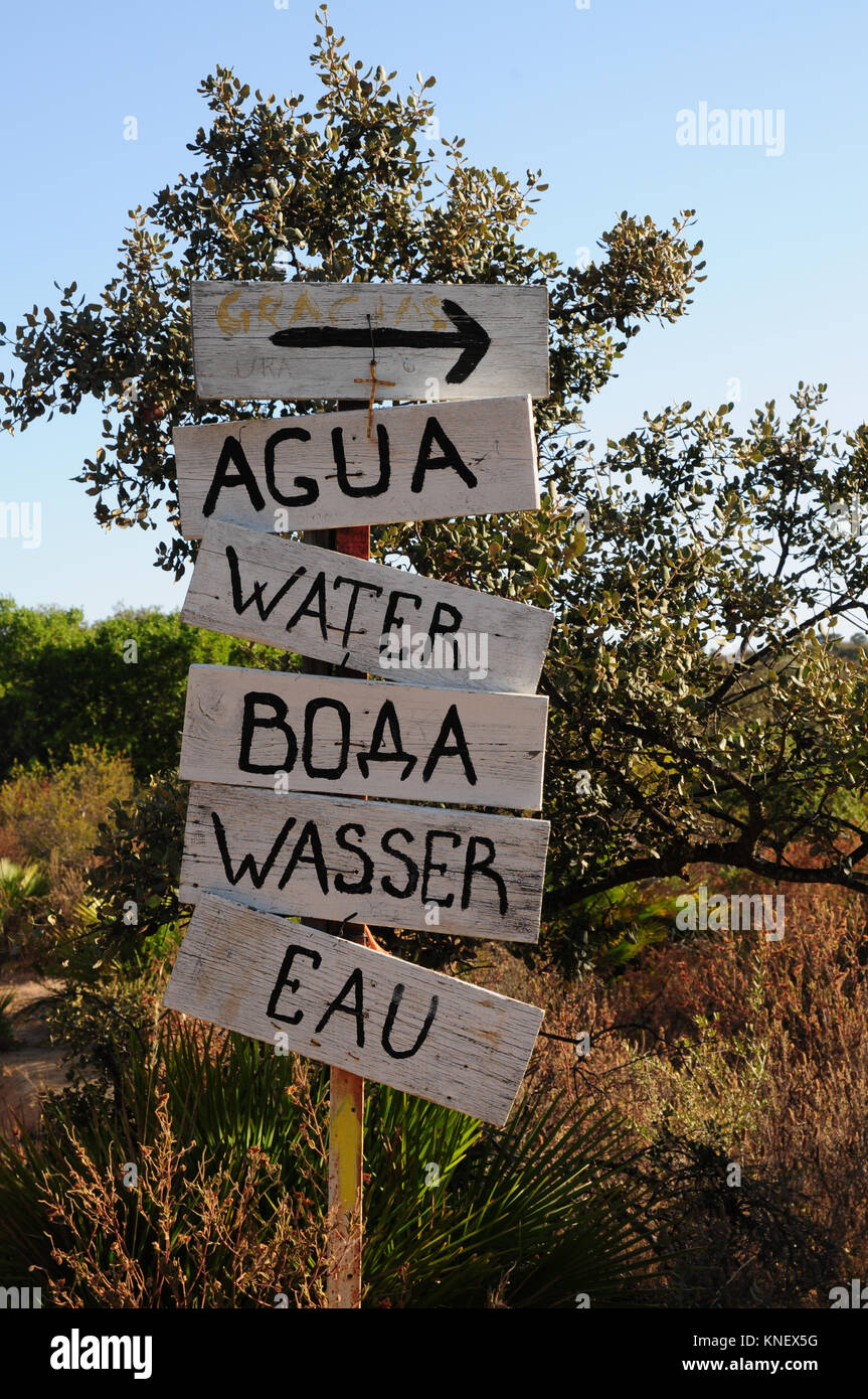 A multi-lingual signpost for a water pump on the Via de la Plata route in Spain. Water is in short supply when crossing the arid heart of Spain. Stock Photo