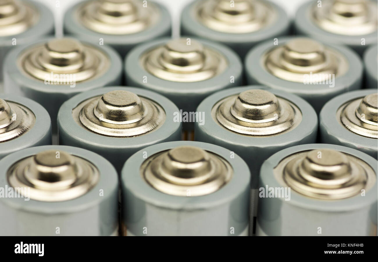 Multiple rows of standing AA batteries with blurred backgrounds Stock Photo