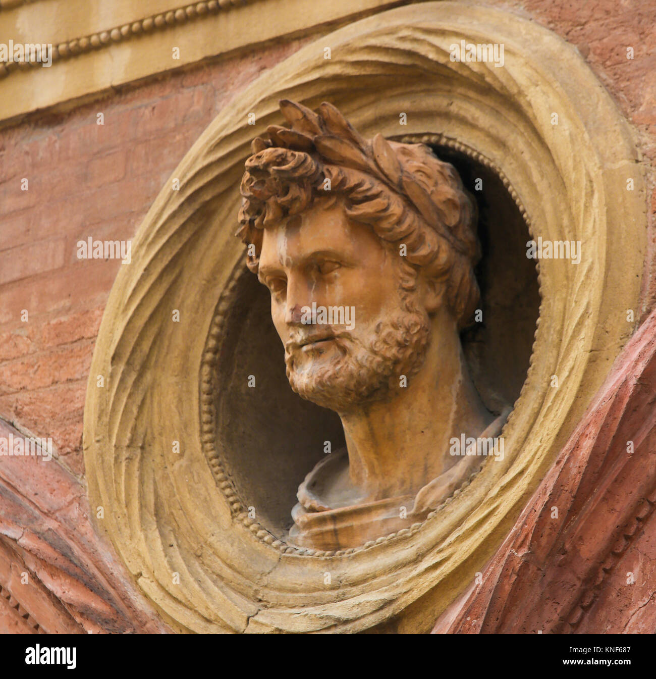 Bust of a Roman Emperor with a laurel crown at the Palazzo Bolognini Amorini Salina, a Renaissance architecture palace located on Piazza Santo Stefano Stock Photo
