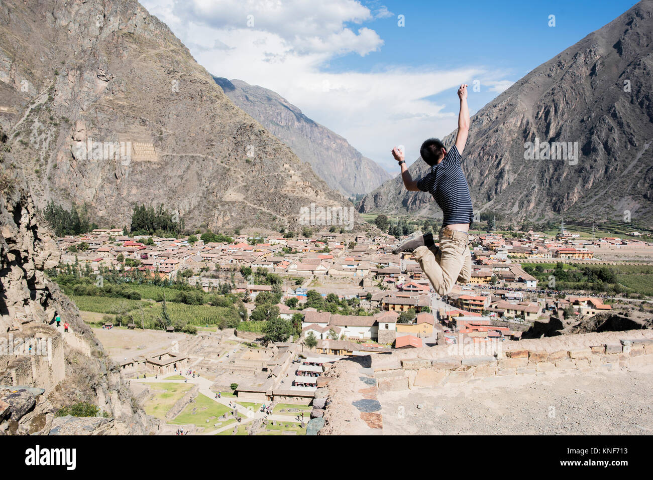 Man Jumping at the top of Ollantaytambo Ruins, Cusco, Peru, South America Stock Photo