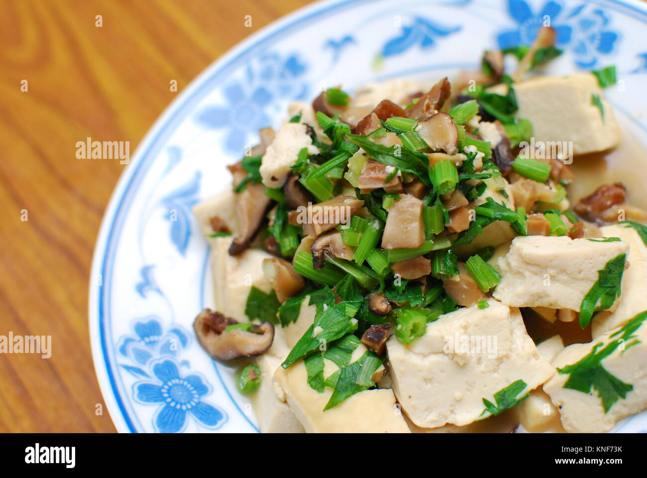 Simple vegetarian bean curd cuisine topped with mushroom cubes.Asia