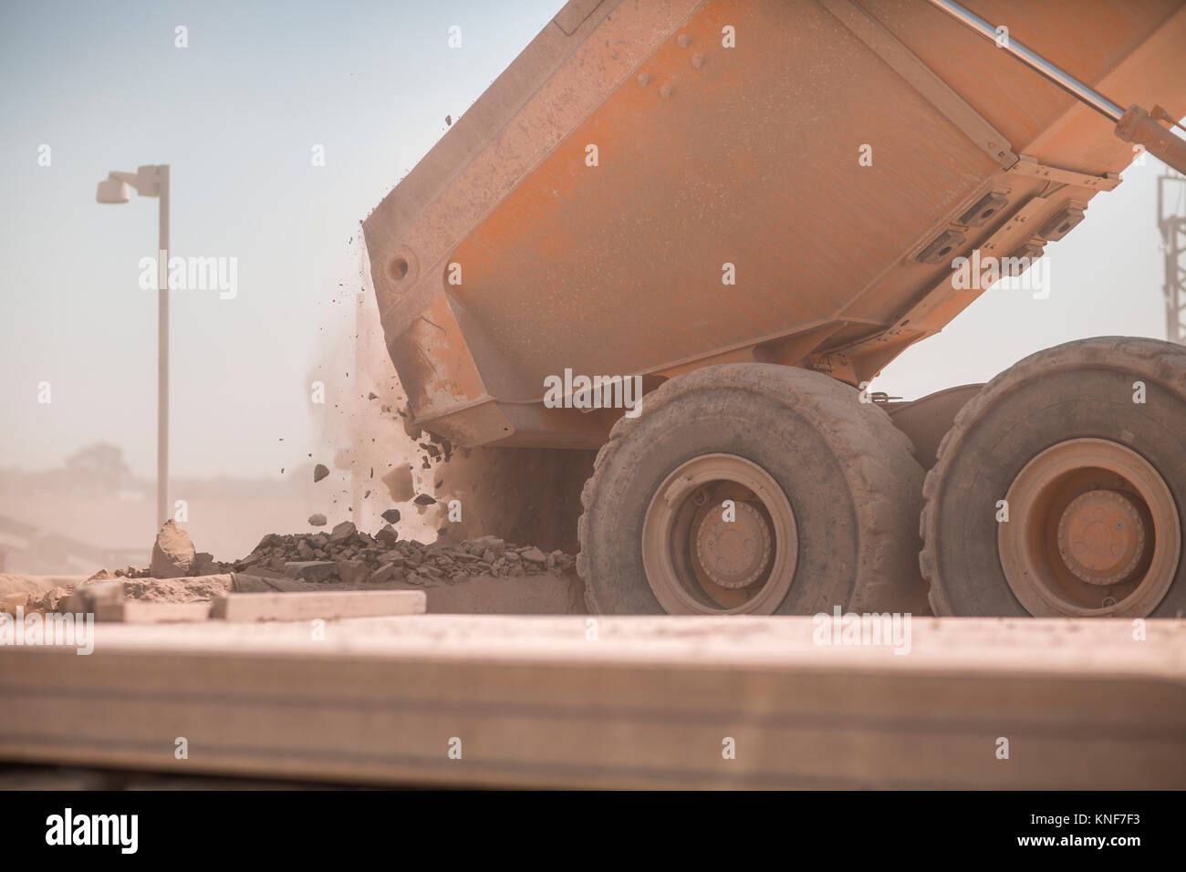 Dump truck in quarry, tipping load of stones Stock Photo Alamy