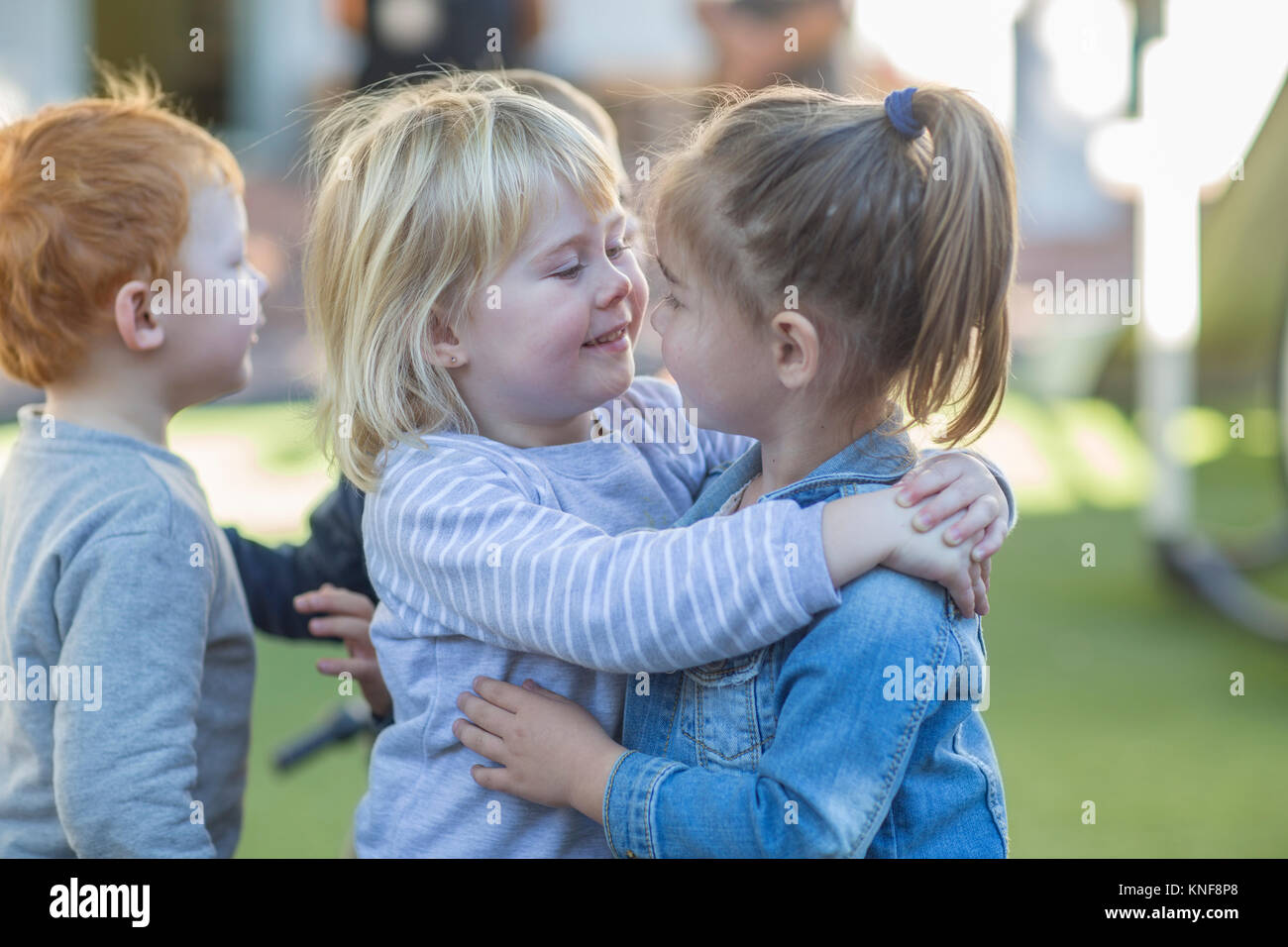 Two school girls hugging hi-res stock photography and images - Alamy