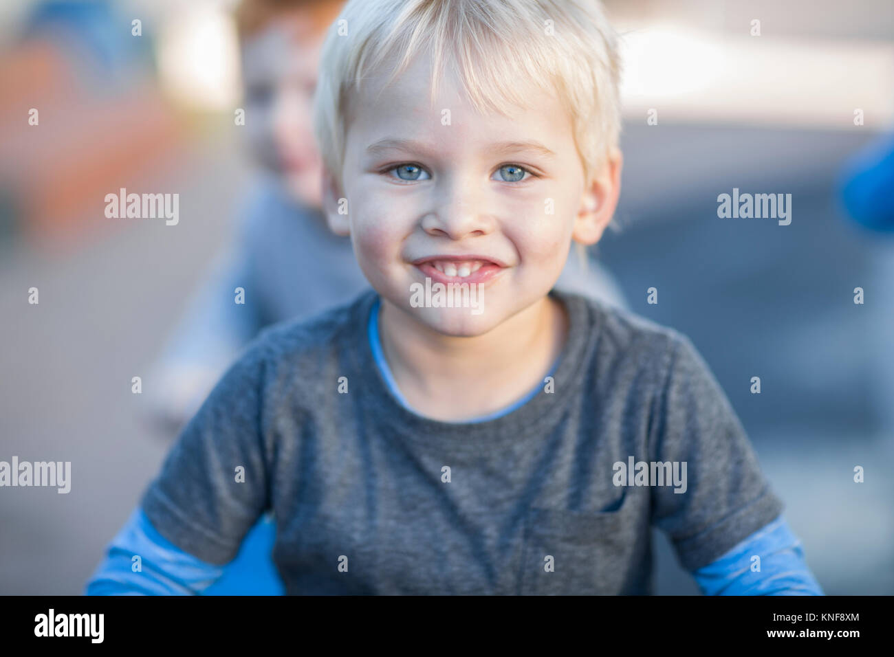 Blond haired boy at preschool, portrait in garden Stock Photo