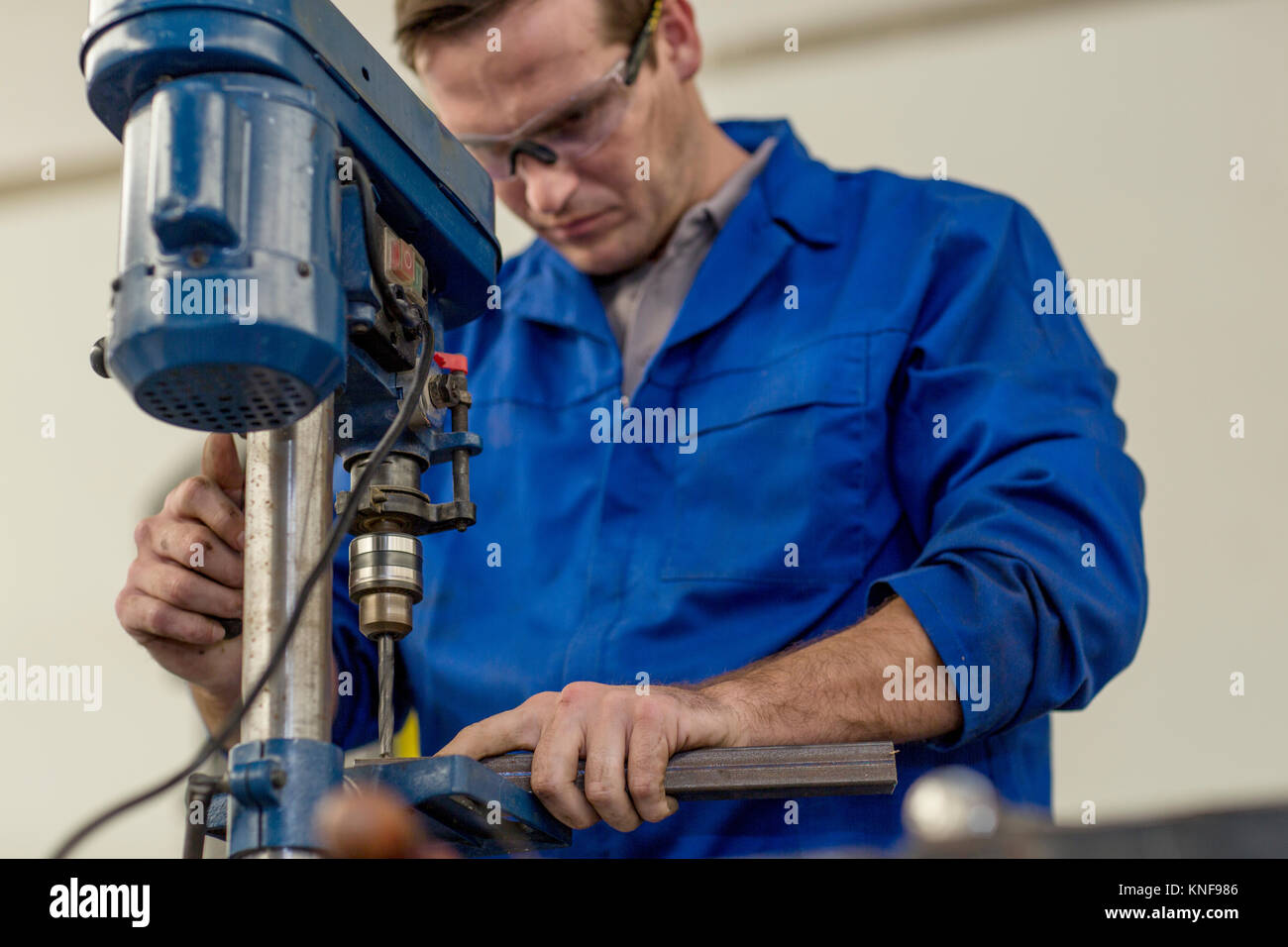 Car mechanic using drill in repair garage Stock Photo Alamy
