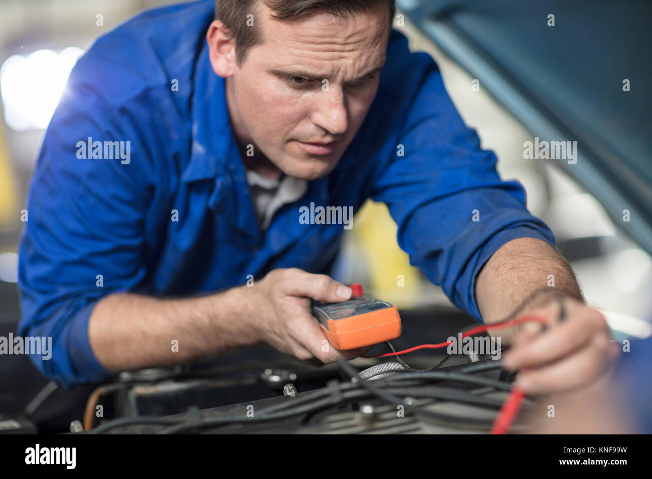 Car mechanic testing car engine in repair garage Stock Photo Alamy