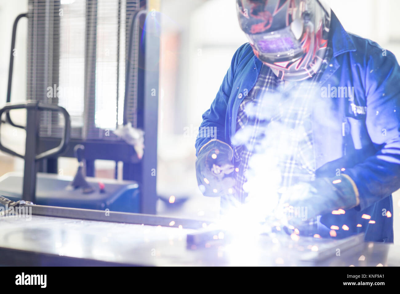 Car mechanic welding in repair garage Stock Photo Alamy