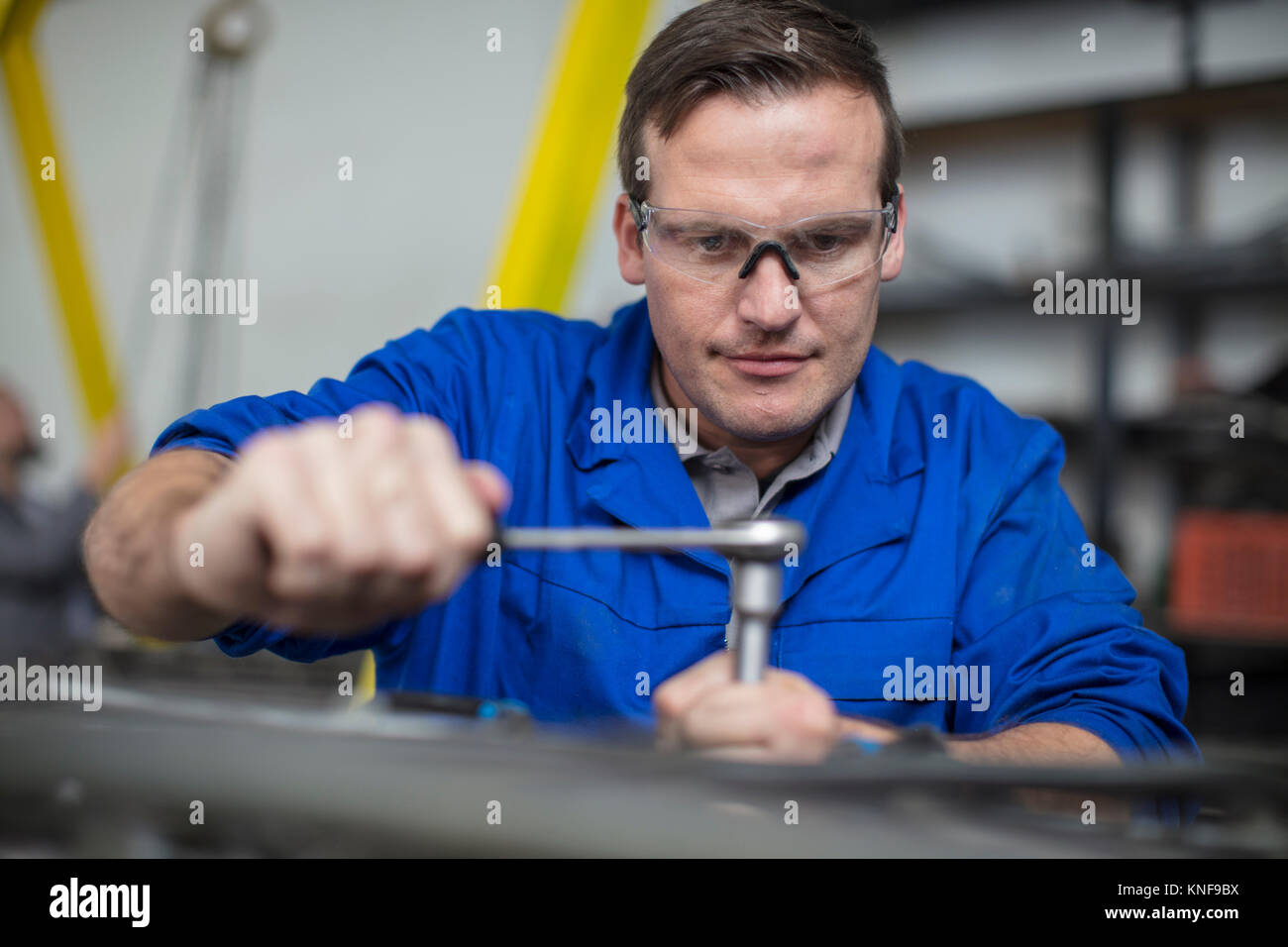 Male car mechanic using wrench in repair garage Stock Photo Alamy
