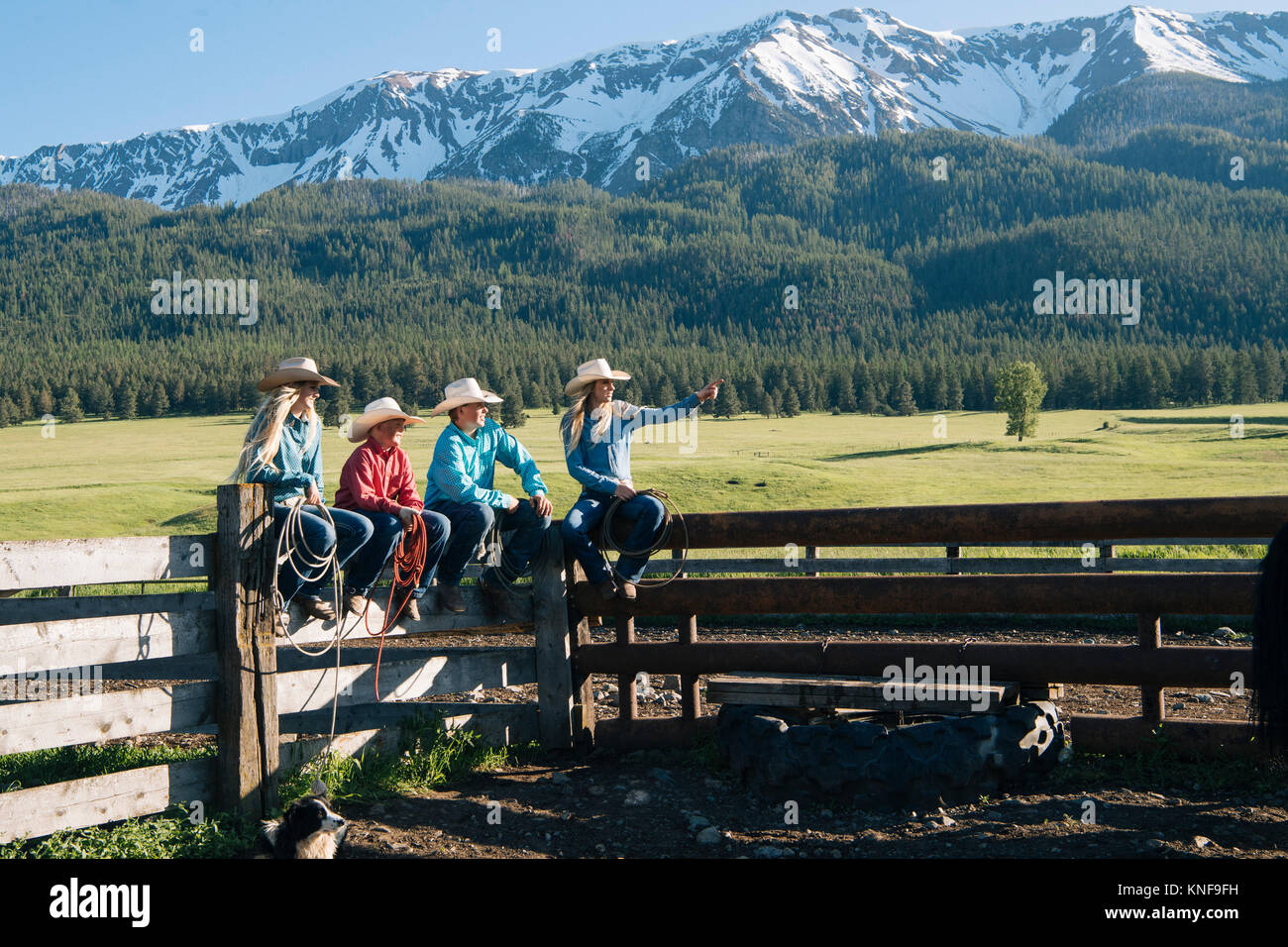 Cowboys and cowgirls on fence, looking away, Enterprise, Oregon, United