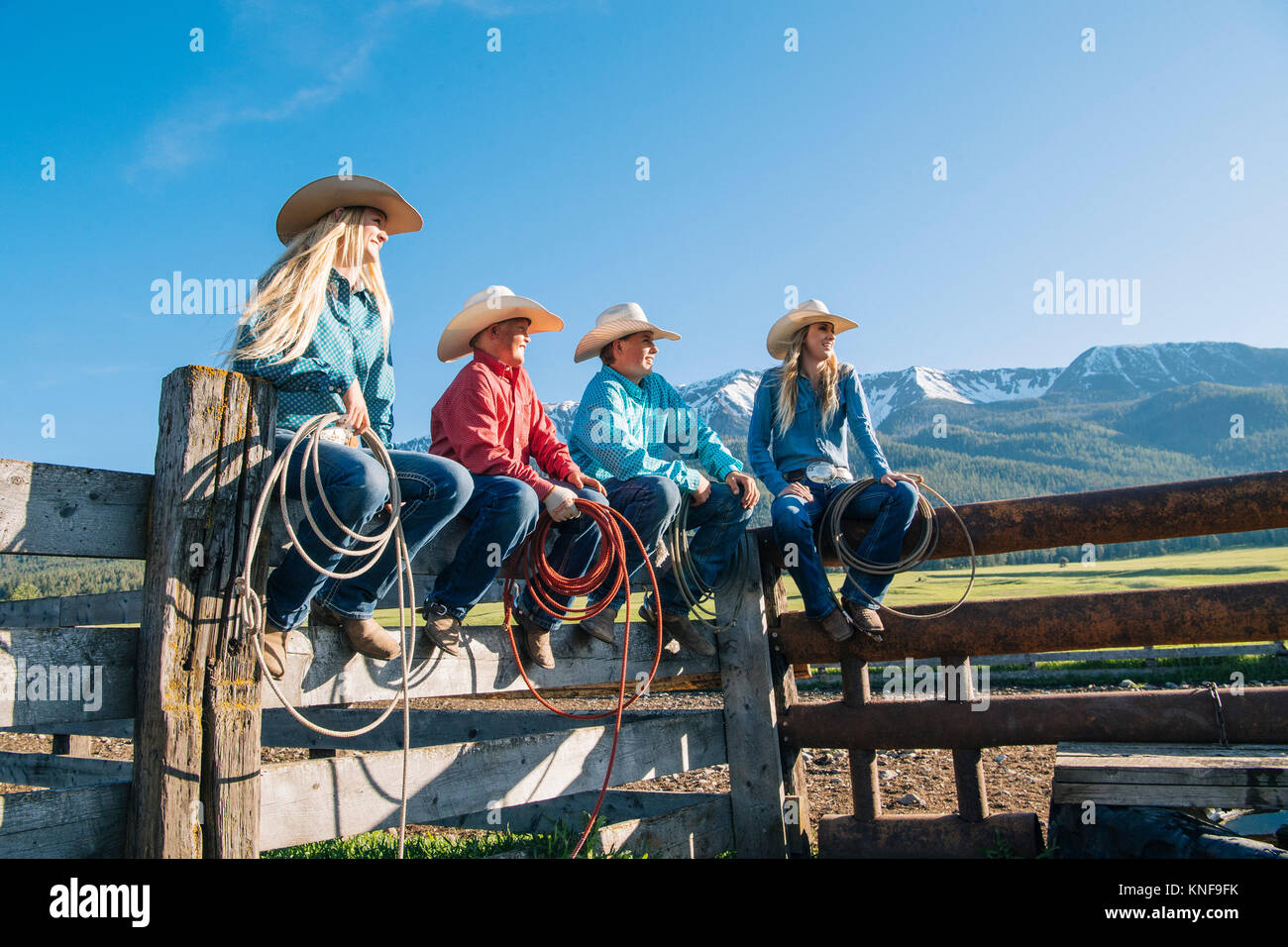 Cowboys and cowgirls on fence, looking away, Enterprise, Oregon, United