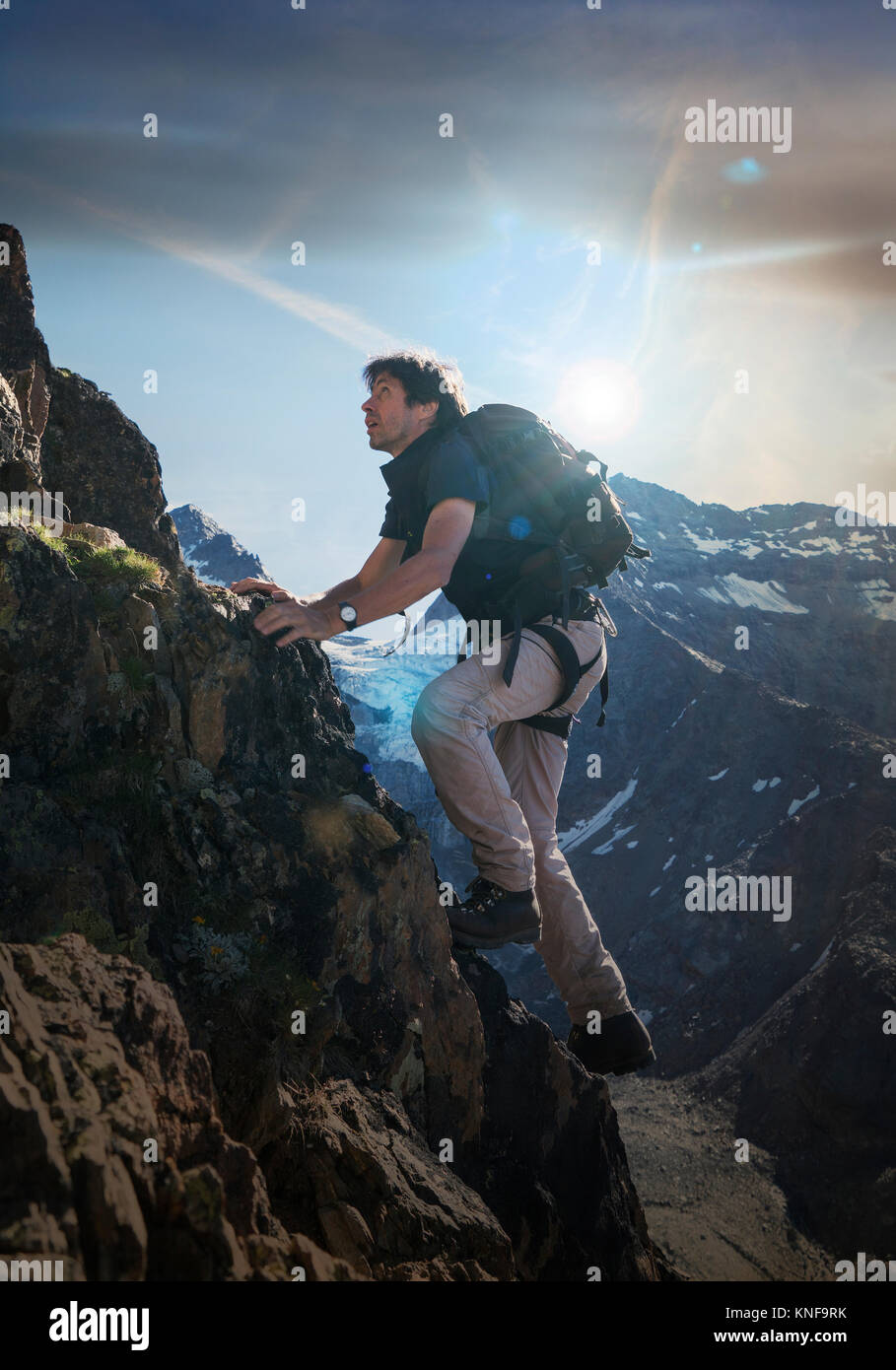 Mature male climber climbing up Jegihorn, Valais, Switzerland Stock Photo