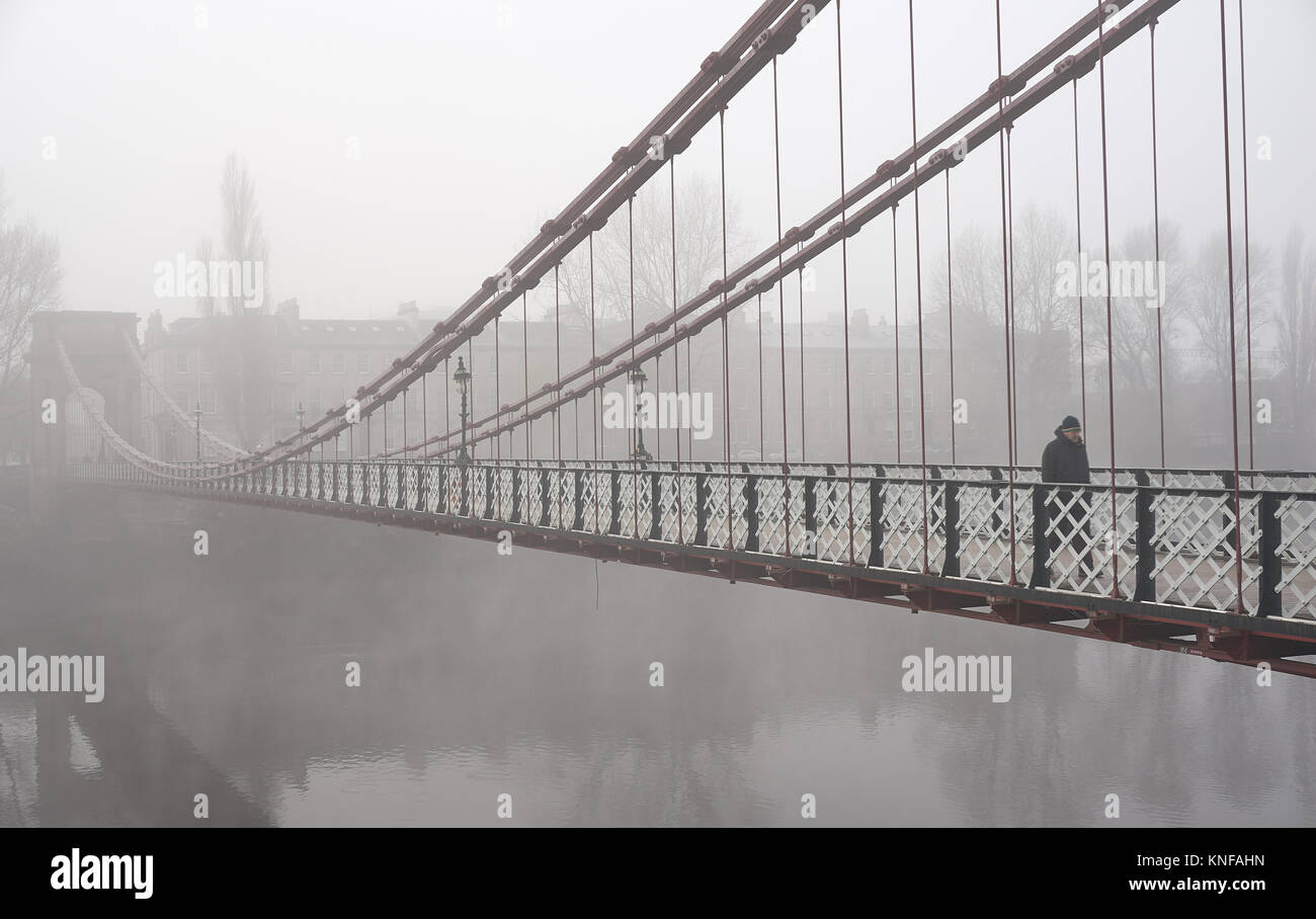 Glasgow, UK, 10th December 2017, South Portland suspension footbridge over the river Clyde in Glasgow in foggy weather. Stock Photo