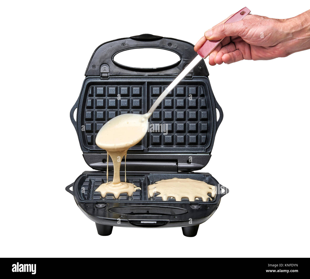 Hand with big spoon Pouring fresh pastry into waffle maker isolated on white Stock Photo