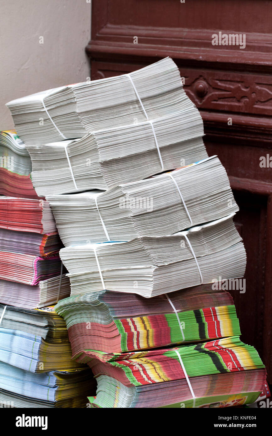 stack of newspapers ads lying on the threshold of the house Stock Photo
