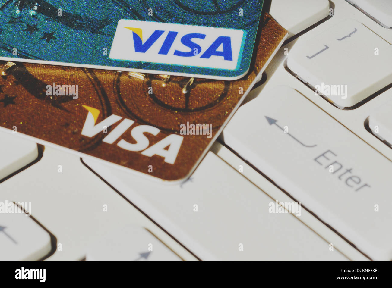 Visa payment system credit cards on computer keyboard Stock Photo