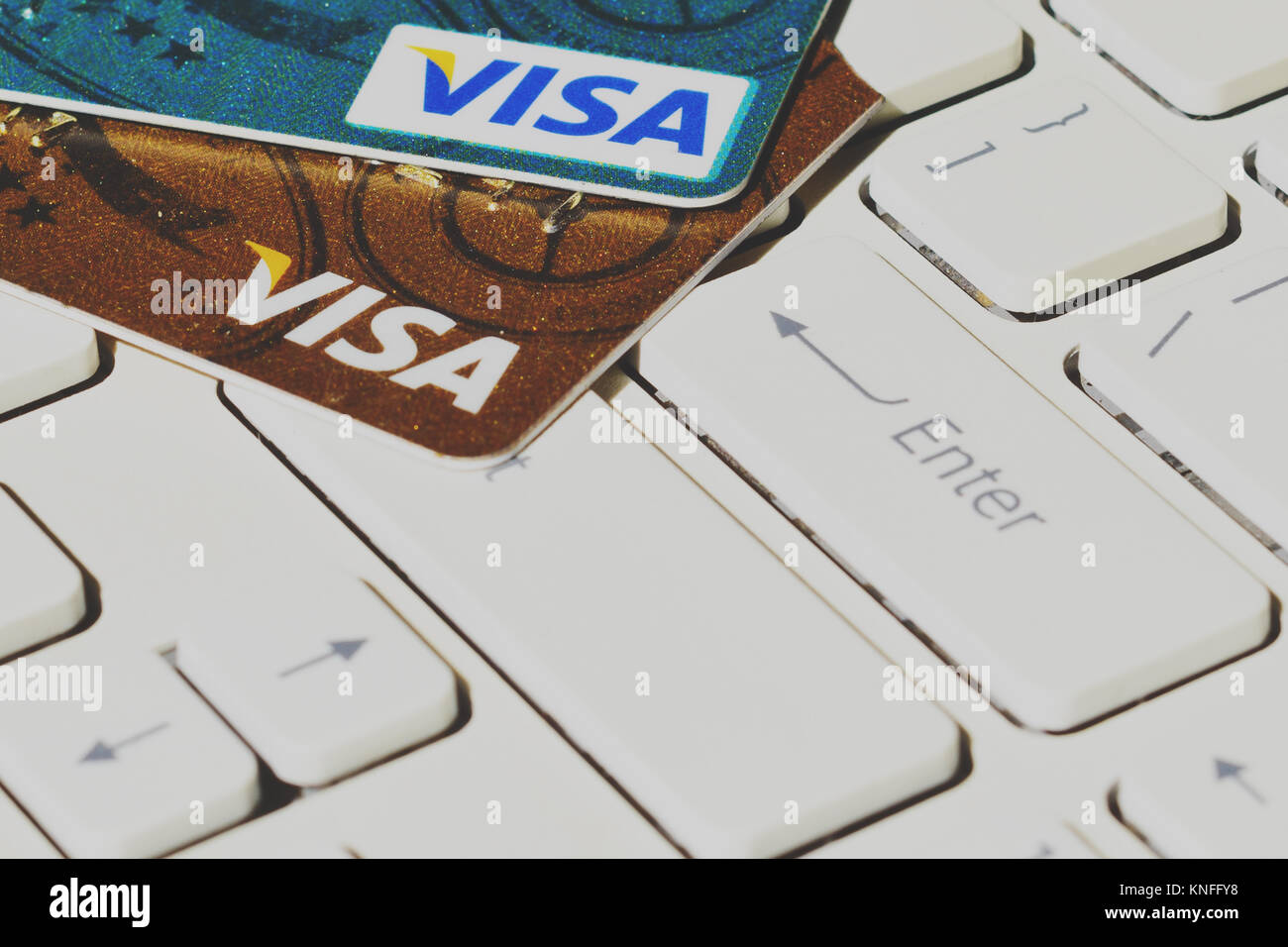 Visa payment system credit cards on computer keyboard Stock Photo