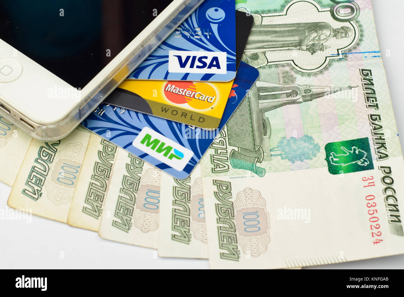 Plastic cards of VISA, Mastercard and MIR payment systems on paper banknotes. Russia, Volgograd region, 22 March 2017 Stock Photo