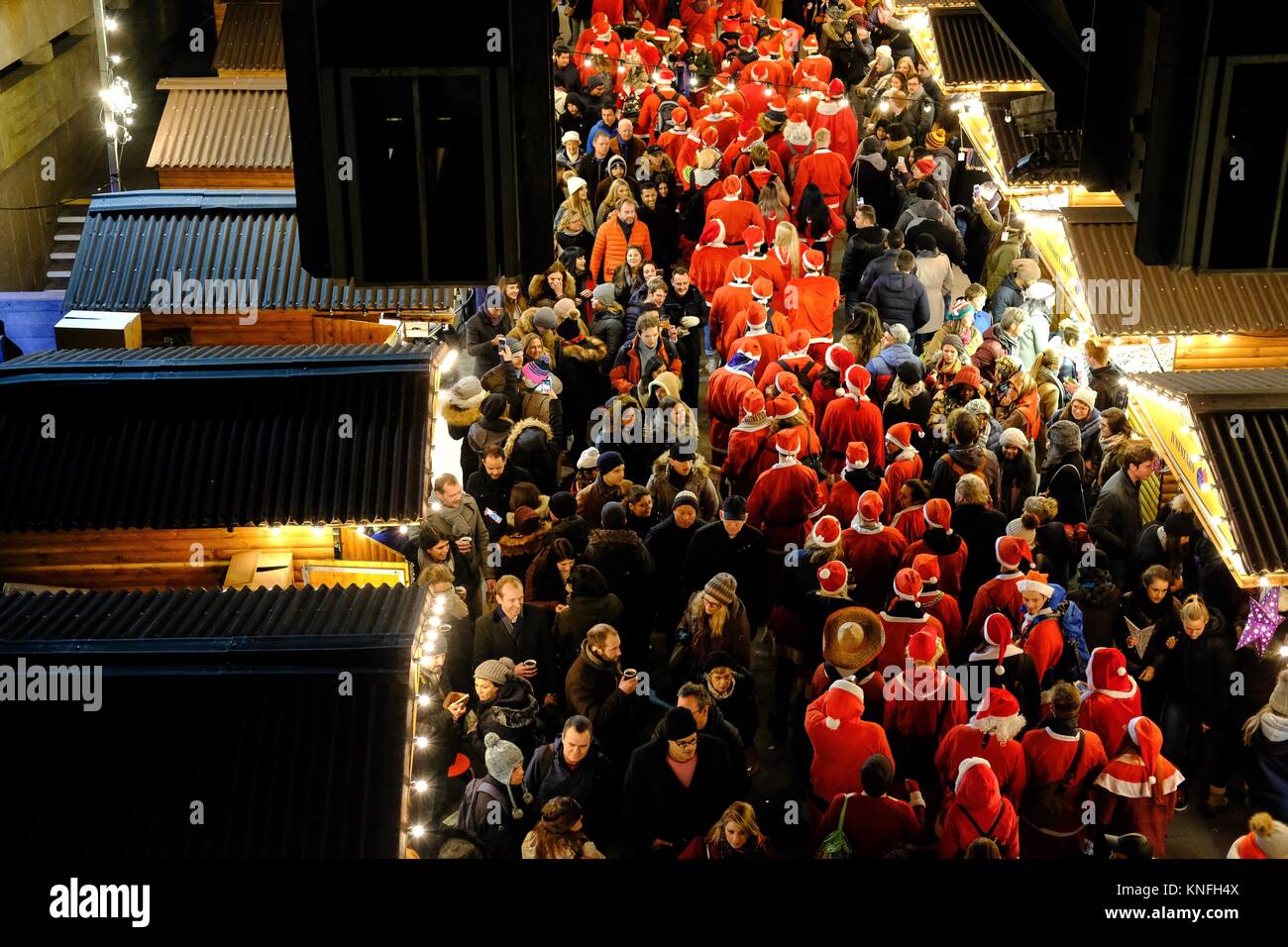Thousands of revellers dressed as Santa descend on London for Santacon yearly in December. Taken on the Southbank of the river Thames near Waterloo Stock Photo