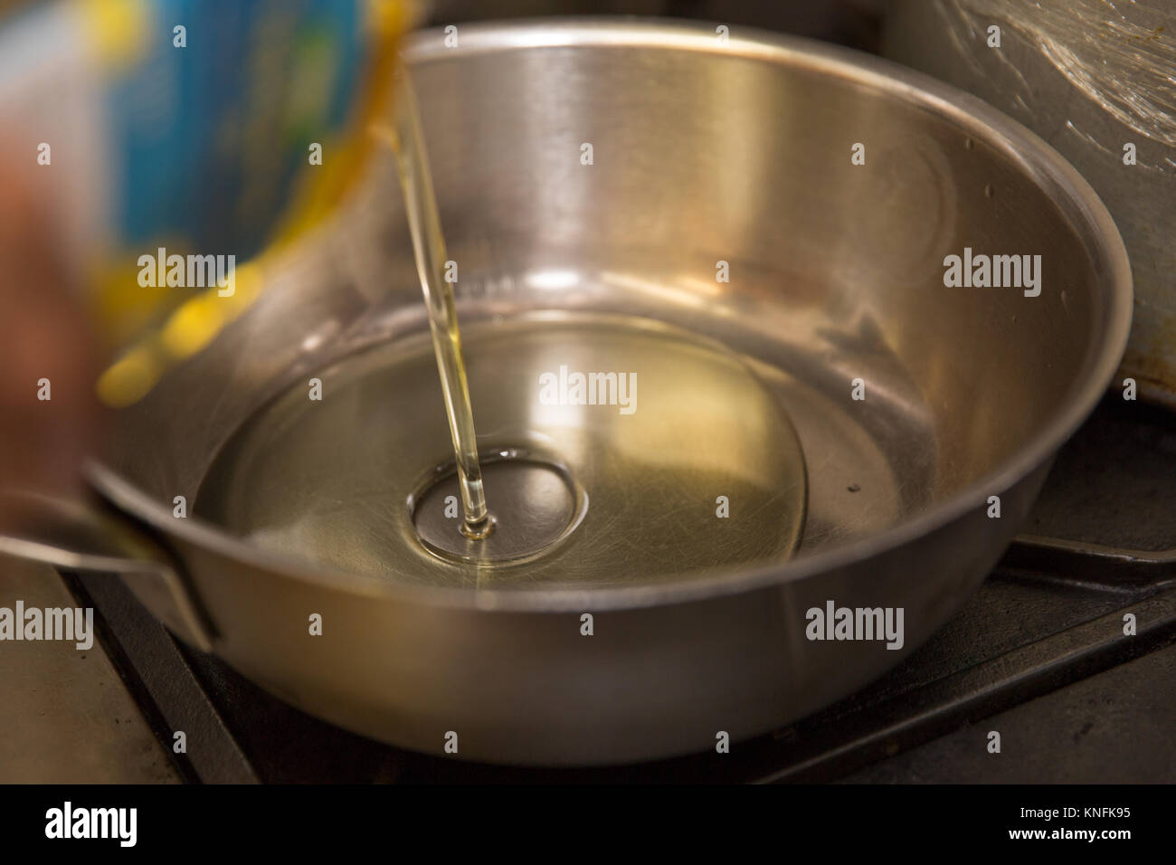 Food Preparation. Oil being poured into a frying pan Stock Photo Alamy