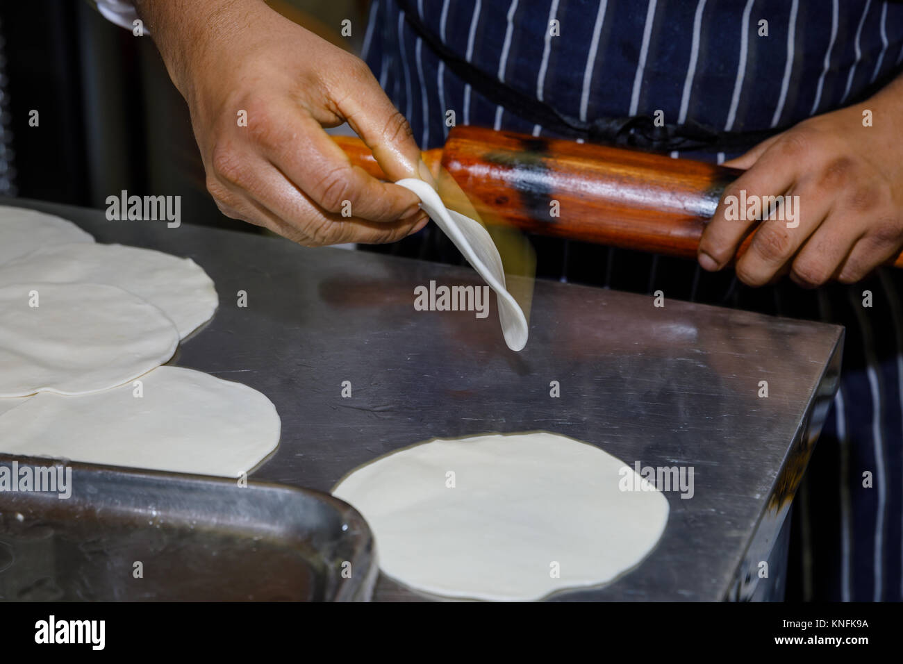 Food Preparation. Chef rolling dough balls Stock Photo