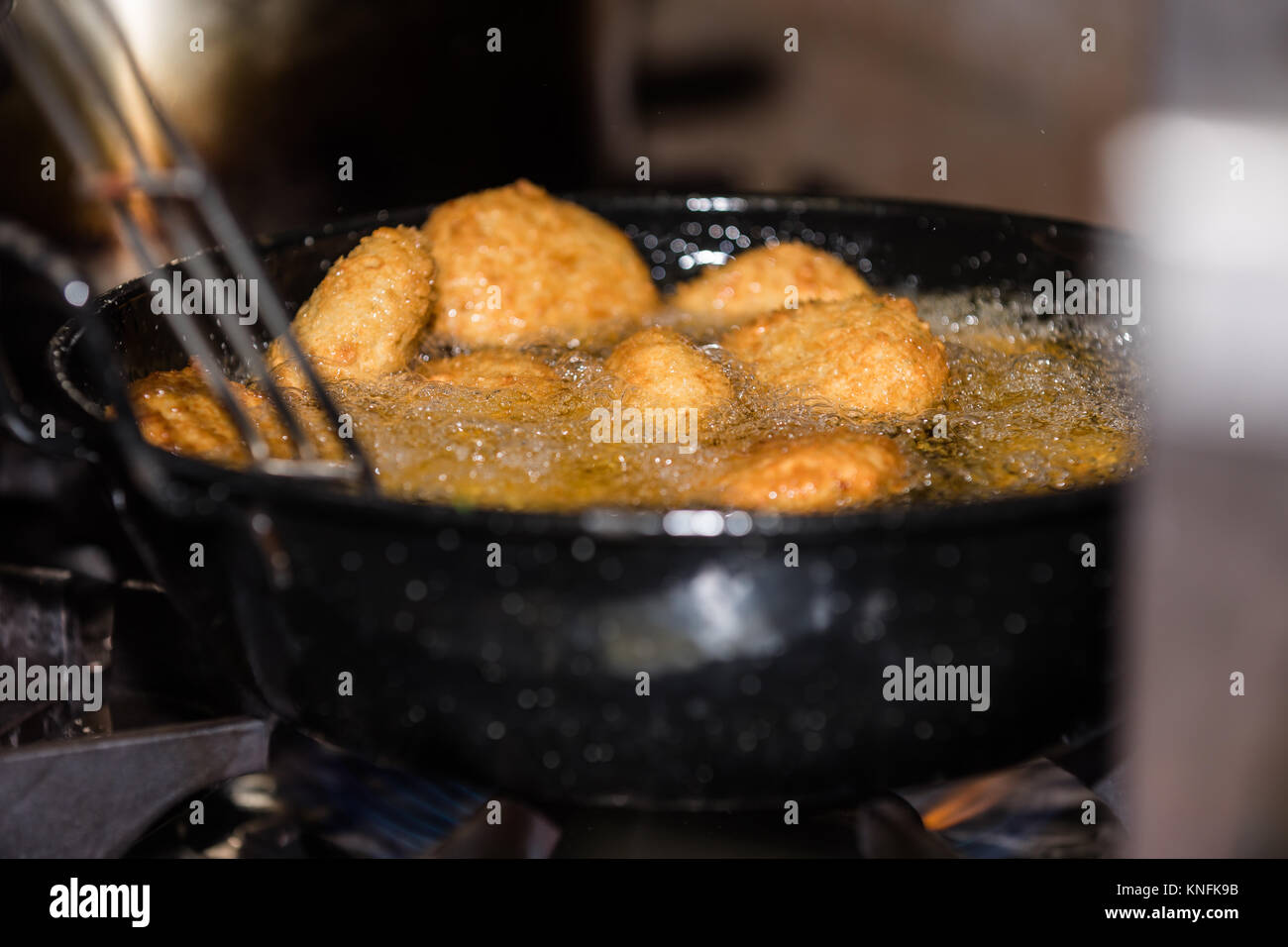Food Preparation. Frying Luchi / Puri Stock Photo