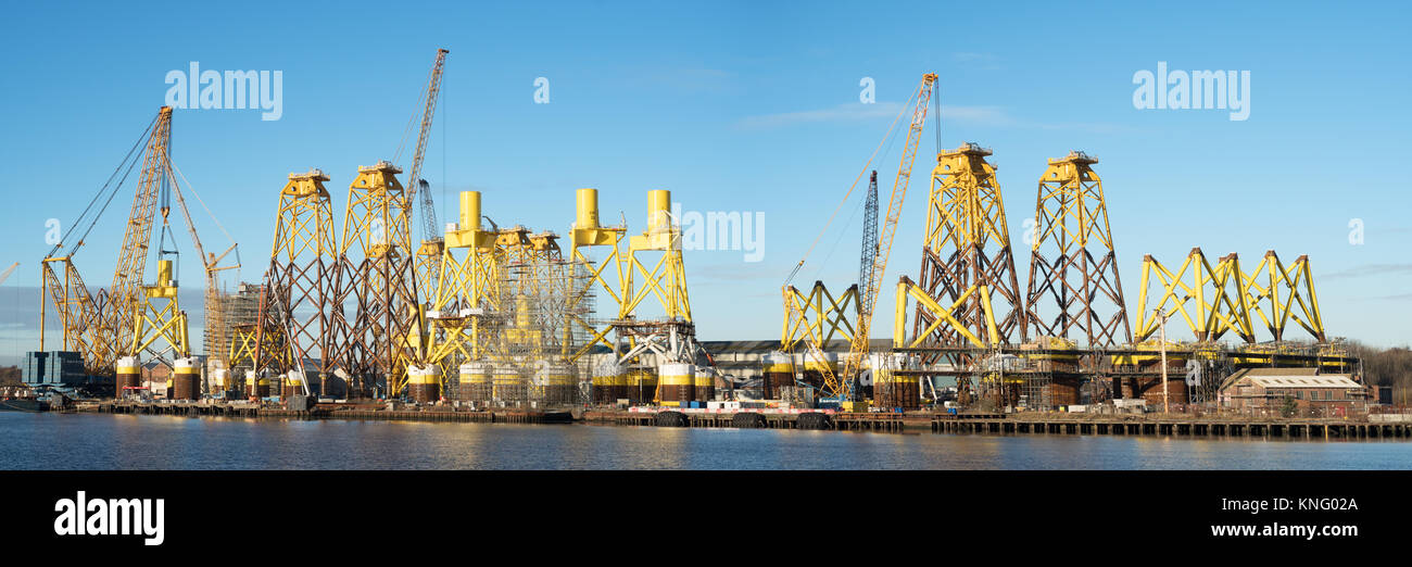 Panoramic view of offshore wind turbine supports being built at Smulders Hadrian Yard on the Tyne, Wallsend, north east England, UK Stock Photo