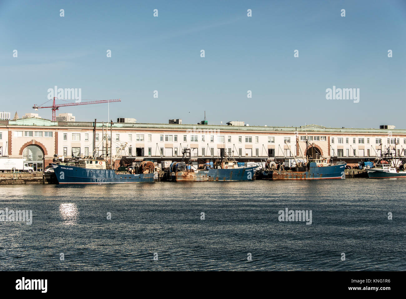 Boston MA USA 04.09.2017 View of harbor from the Boston Waterfront with fishing boat trucks and boats anchored Massachusets USA Stock Photo